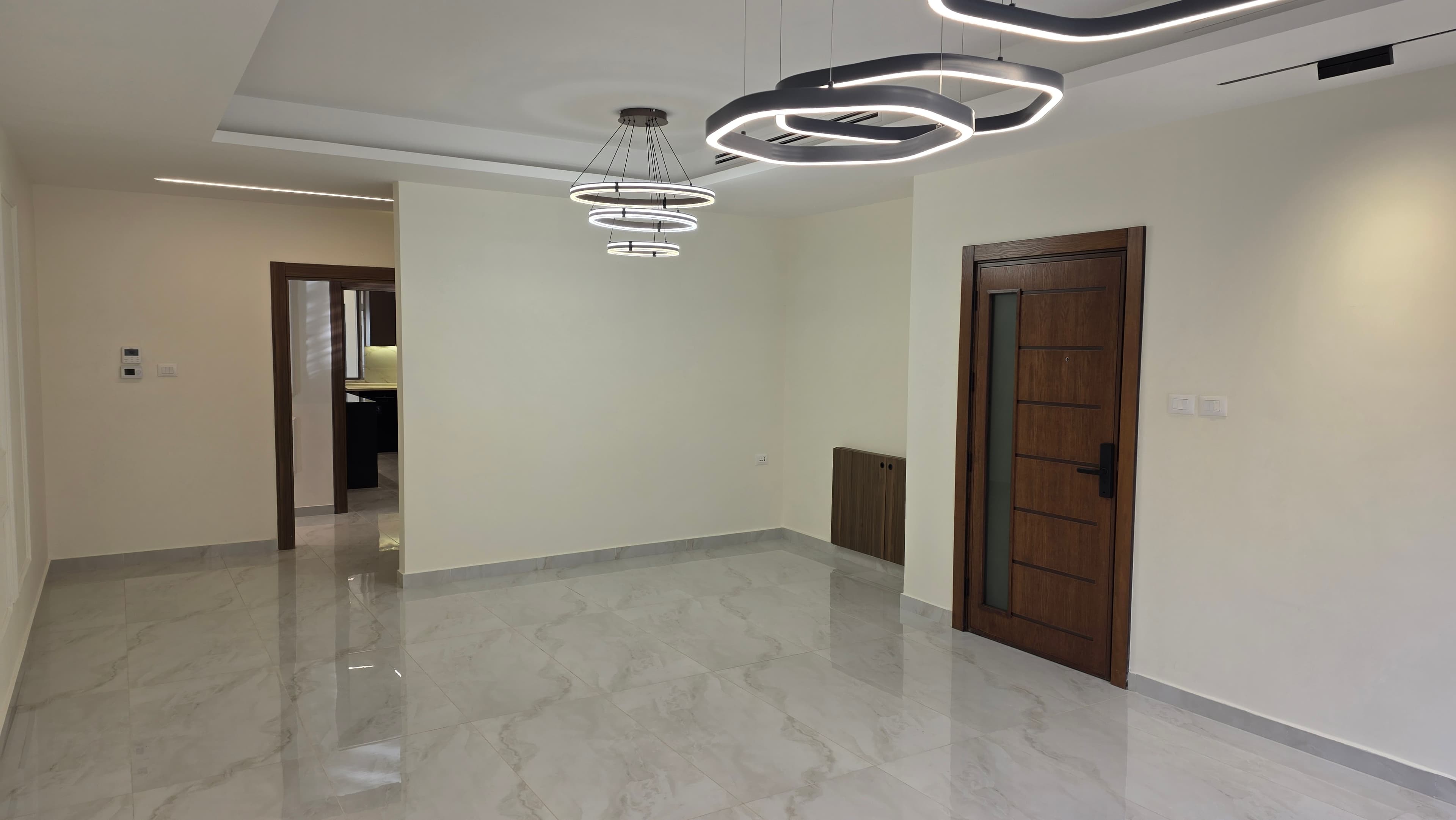 Residence 102 guest salon with orbital ring chandeliers